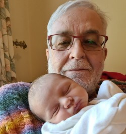 Headshot of John Woodthorpe with a newborn grandchild