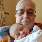 Headshot of John Woodthorpe with a newborn grandchild
