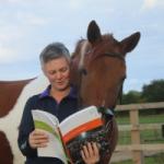 Lucy Anderson with her brown horse study buddy, and a text book