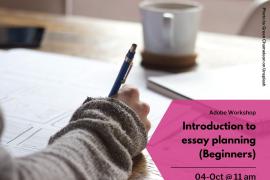 A person writing, with cup of hot drink in background