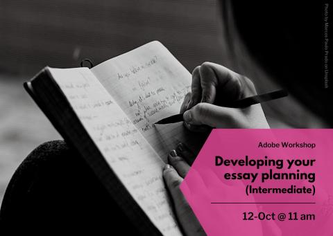 Black and white image of a hand writing in a book