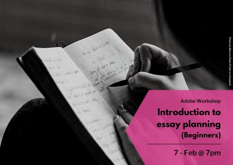 A hand, writing in an open book